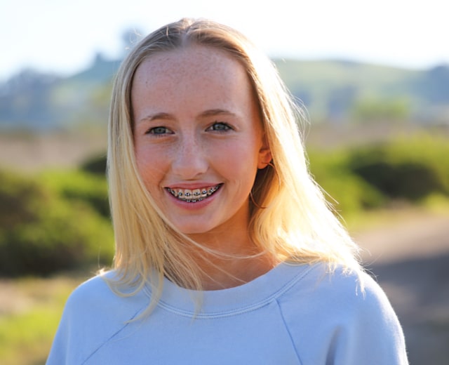 Teen girl smiling with braces at Brooks Orthodontic Studio in Alpharetta, GA